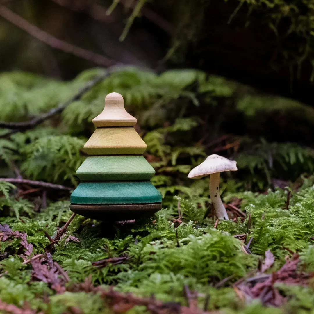 baumkreisel tree on log stand top